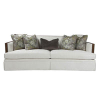 Front view of Callisto upholstered sofa with floral pillows.