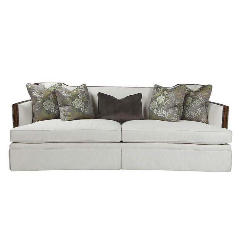 Front view of Callisto upholstered sofa with floral pillows.