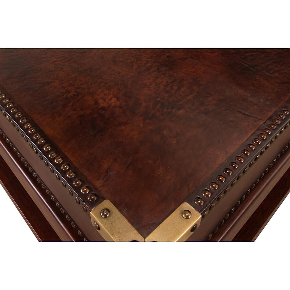 Close-up corner detail, leather coffee table, brass accents.