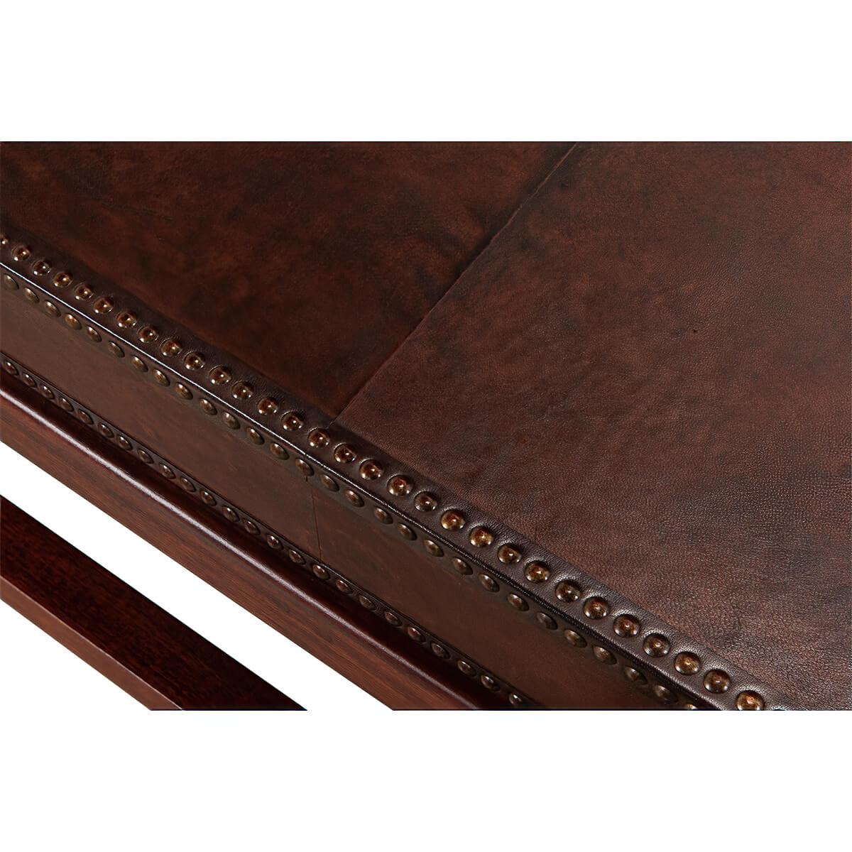 Close-up edge detail, leather coffee table, nailhead design.