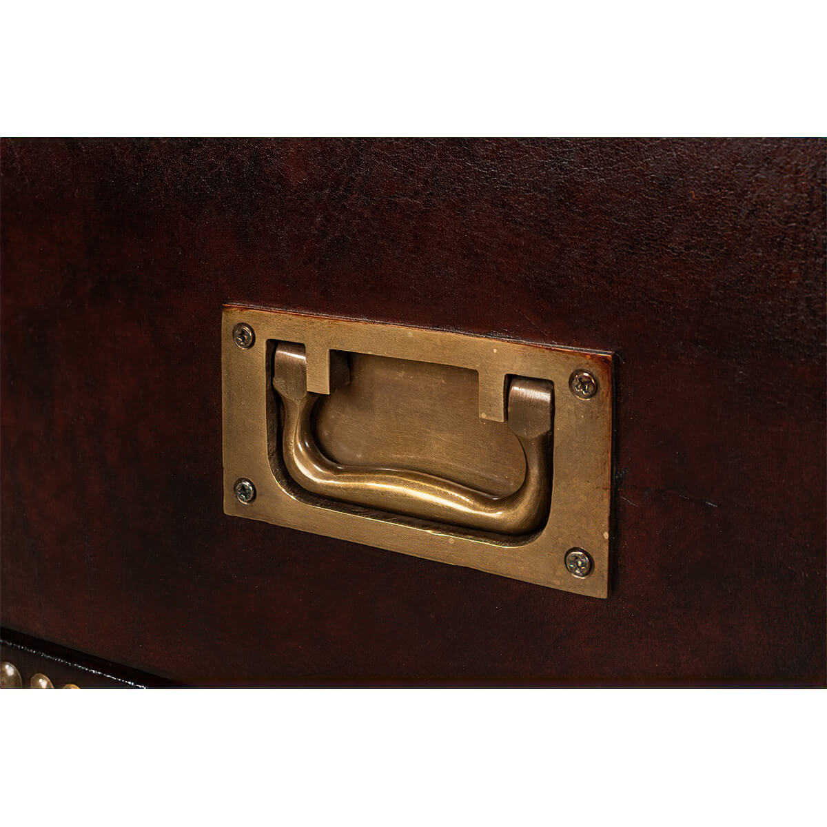 Close-up of brass handle on campaign dresser drawer.