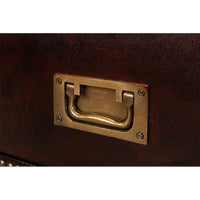 Close-up of brass handle on campaign dresser drawer.