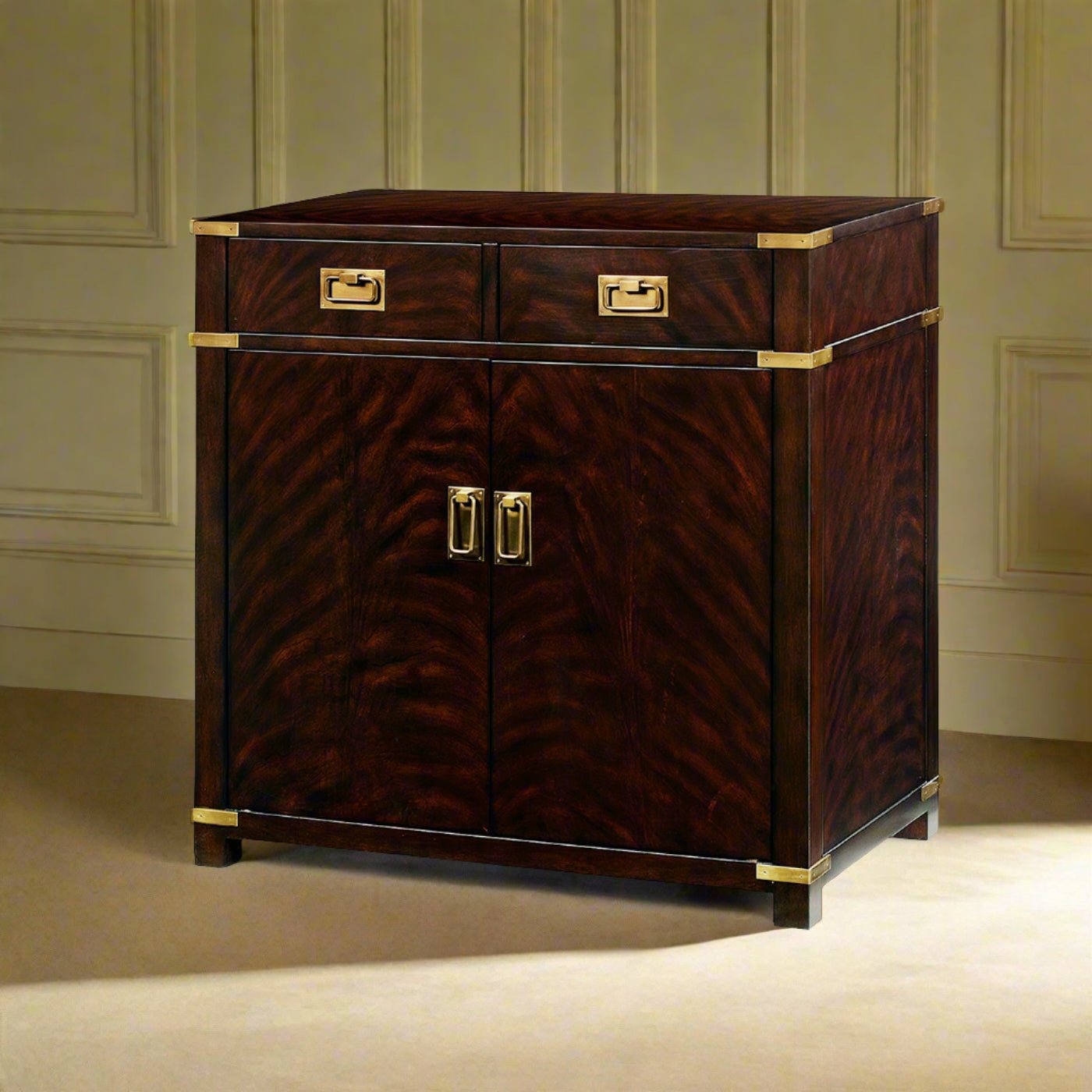 Campaign style mahogany cabinet against paneled wall, front view.