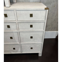 Close-up of dresser drawers, white oak texture, brass accents.