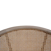 Close-up of caned back detailing on chair.
