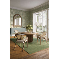 Dining room with four caned back chairs and table.