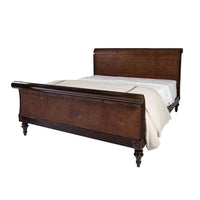 Sleigh bed with cane detailing, side view.