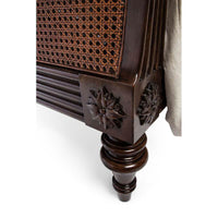 Sleigh bed leg with ornate carving detail.