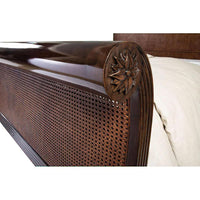 Close-up of sleigh bed cane and carved detail.