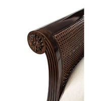 Curved sleigh bed headboard with carved detail.
