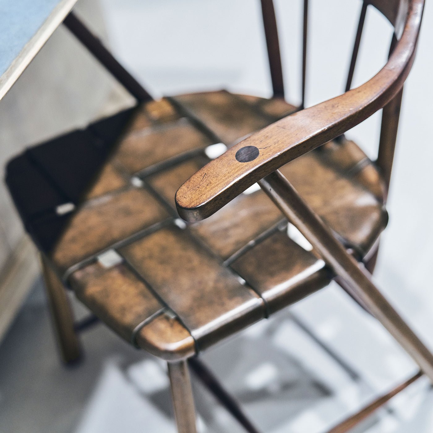 Top view of wicker seat on walnut Captain's Armchair.