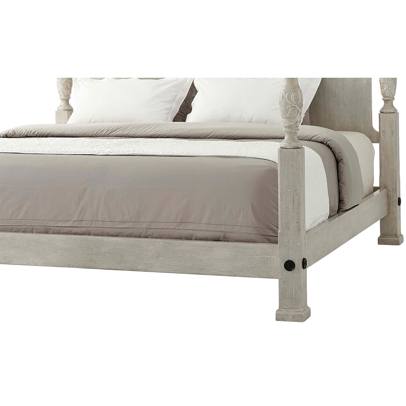 Side view of linen-covered four poster king bed.