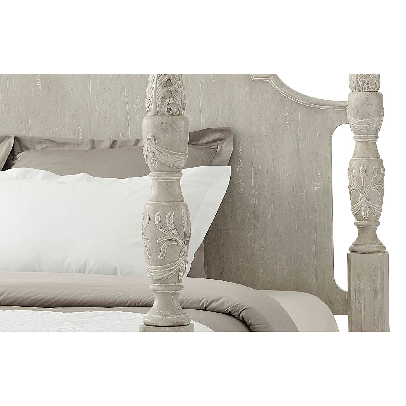 Carved design details on four poster bed frame.