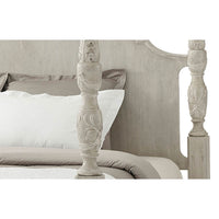 Carved design details on four poster bed frame.