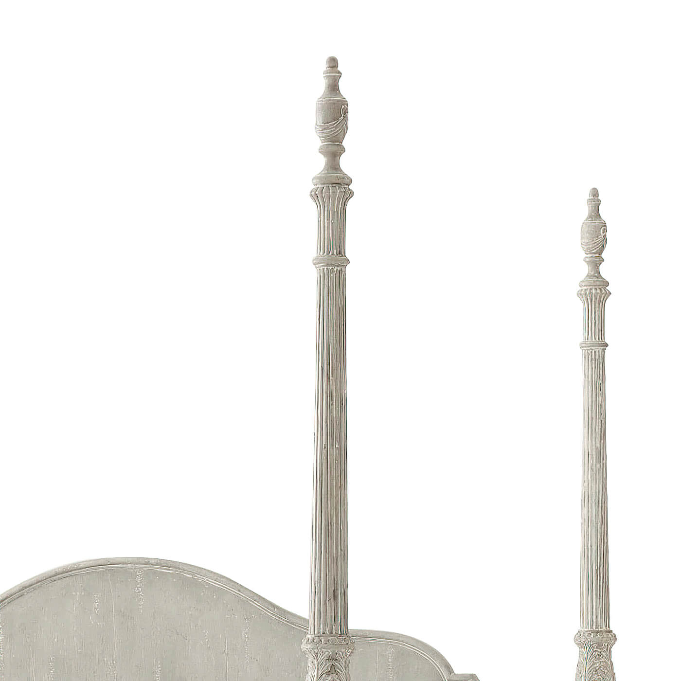 Tall ornate posts on king size four poster bed.