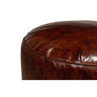Detail of leather texture on round stool corner.