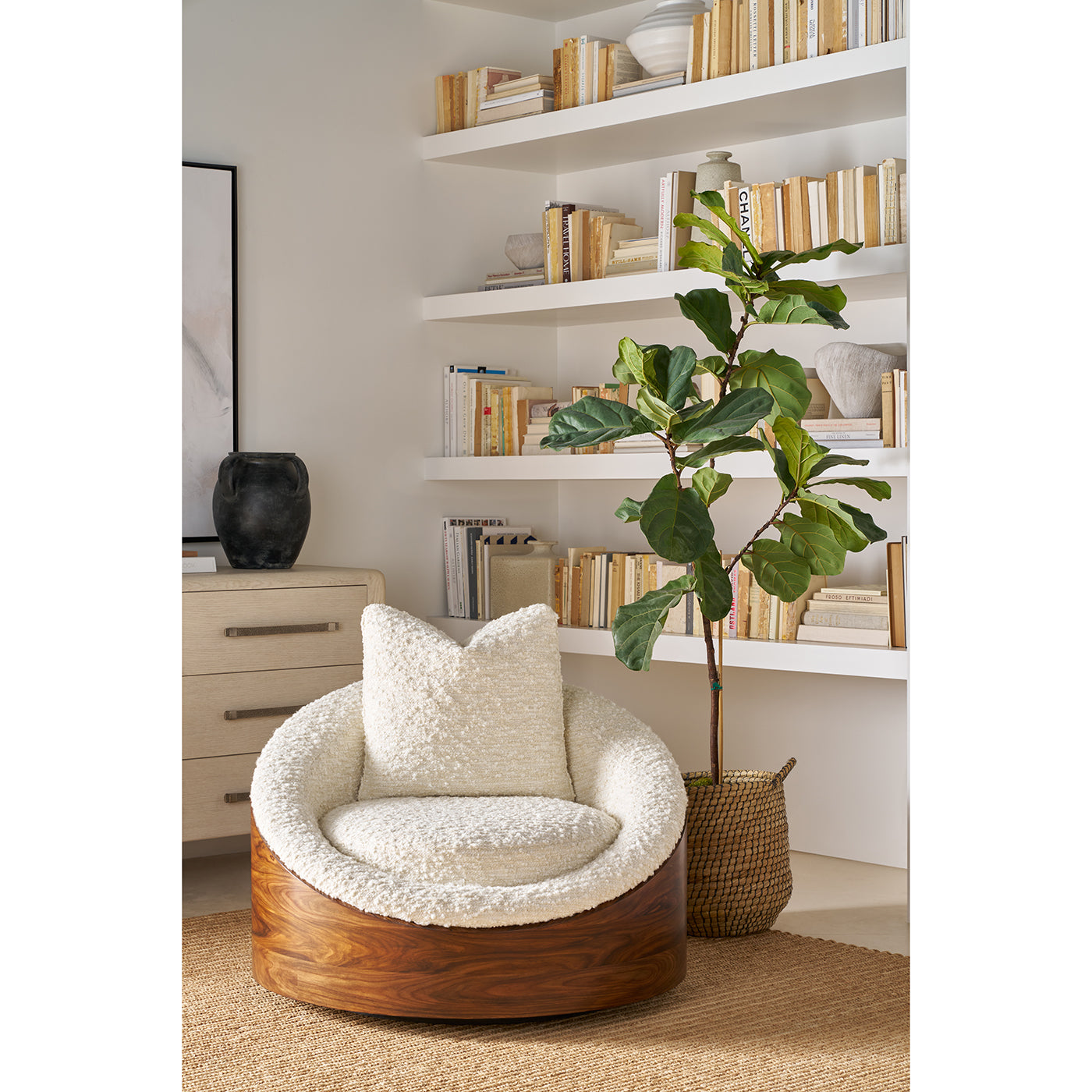 Accent chair in stylish room, plant and bookshelf.