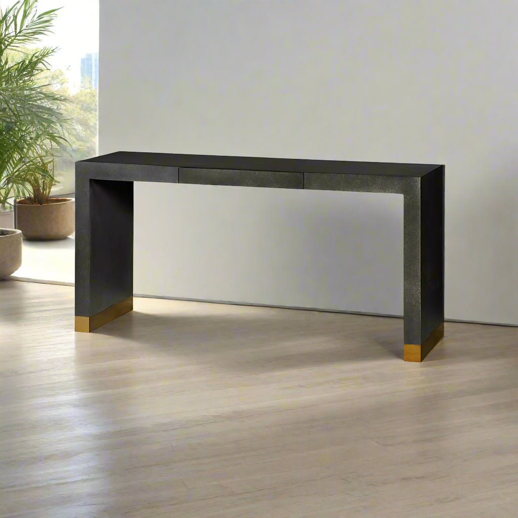 Console table against bright window, indoor plants nearby.