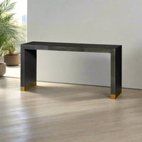 Console table against bright window, indoor plants nearby.