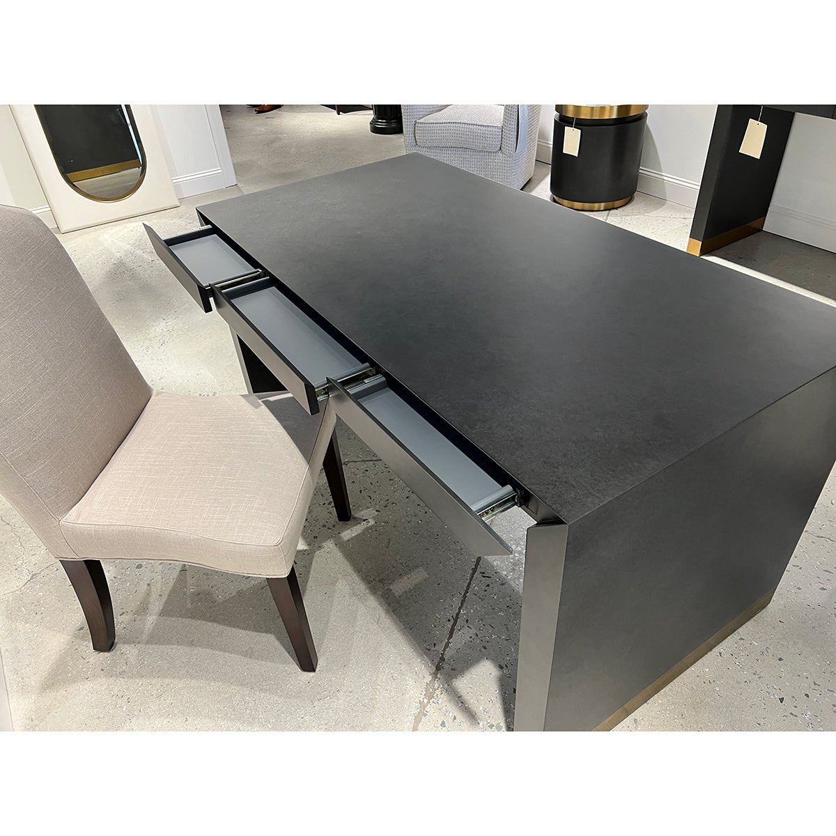Open charcoal desk drawers showcasing interior compartments.