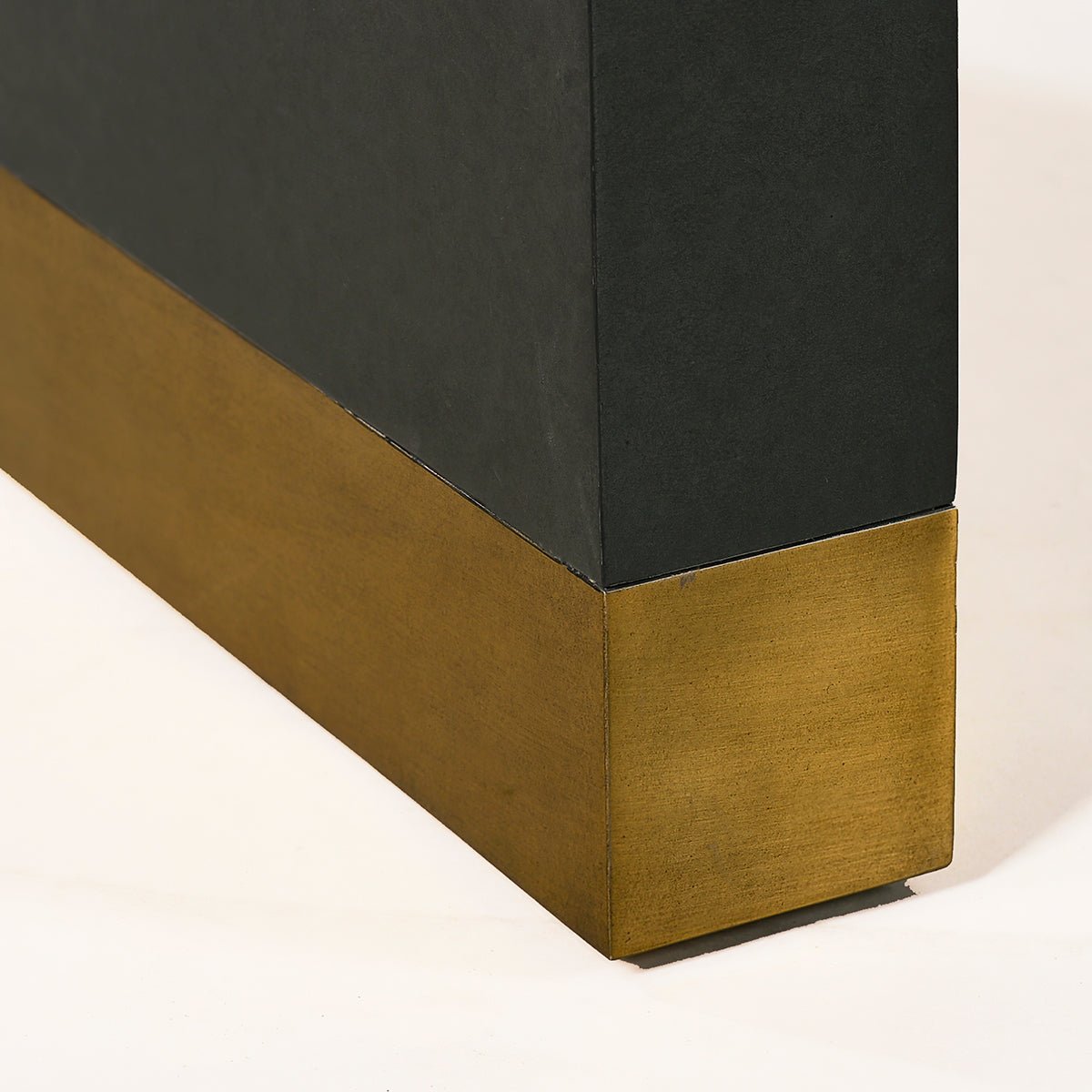 Gold accent detail on bottom of charcoal desk leg.
