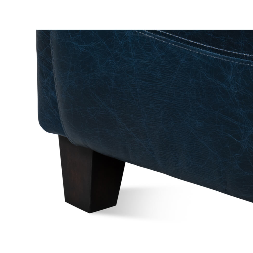 Close-up, front leg detail on club chair.