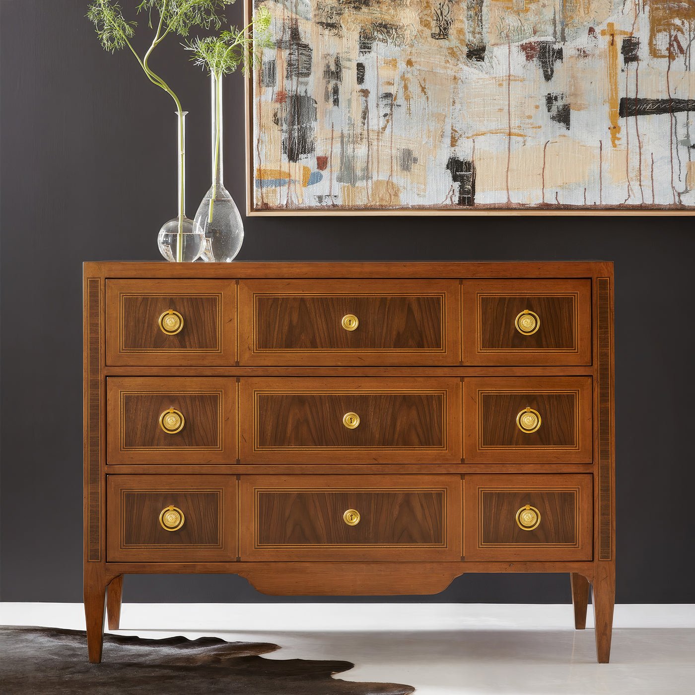 Chest of drawers in room setting with abstract painting.