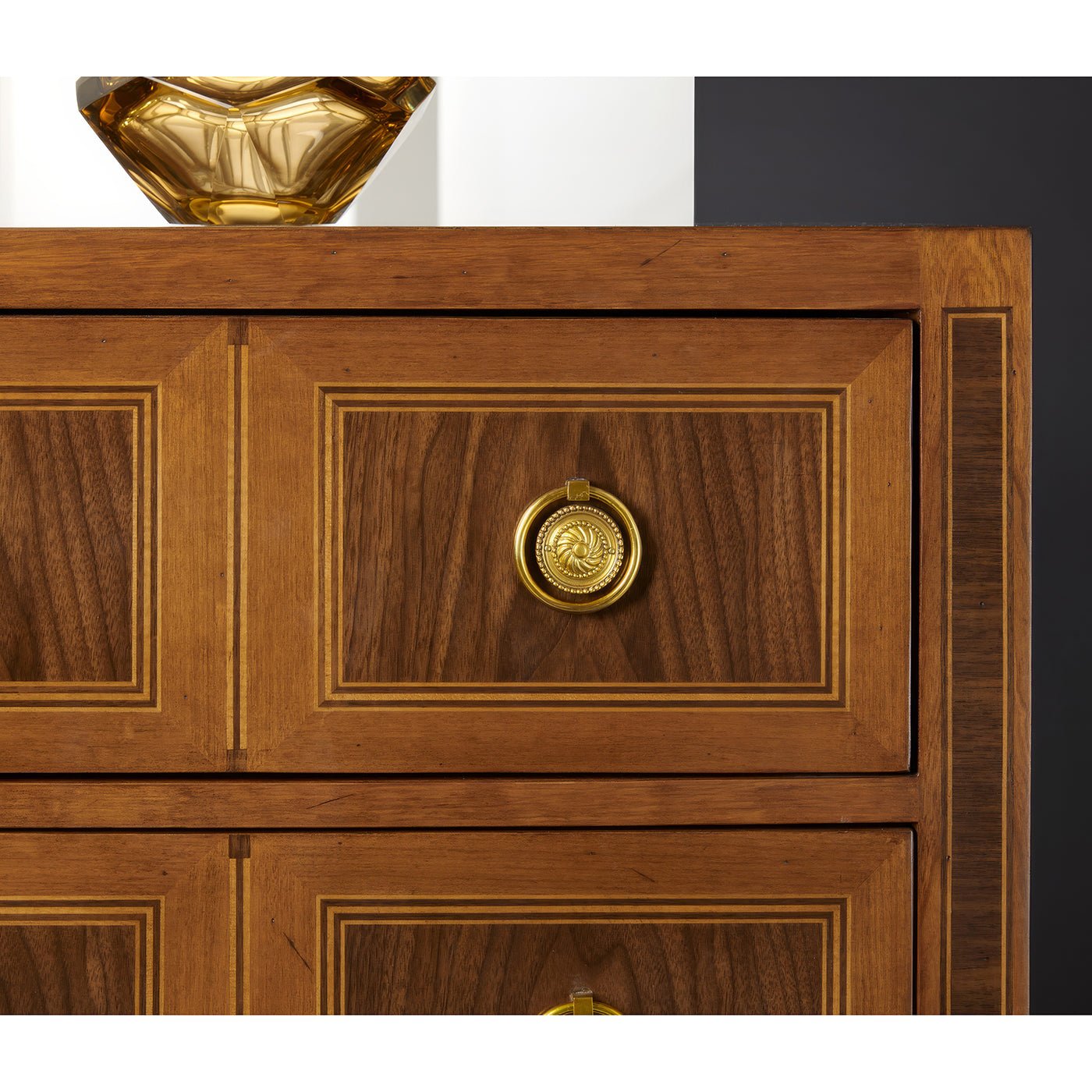 Detailed view, gold handle on chest of drawers.