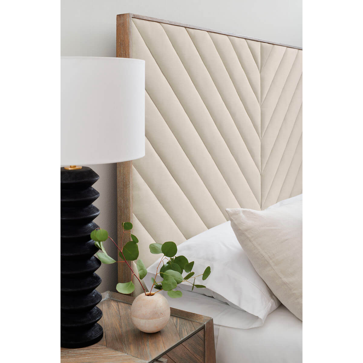 Detail of headboard on chevron tufted upholstered queen bed.