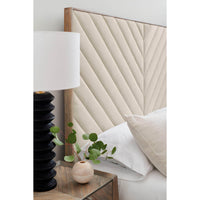 Detail of headboard on chevron tufted upholstered queen bed.