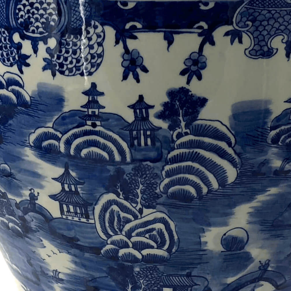 Close-up of landscape artwork on porcelain planter.