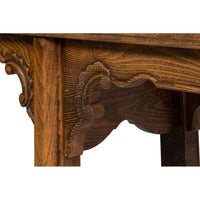 Detailed view of ornate carving under console table top.