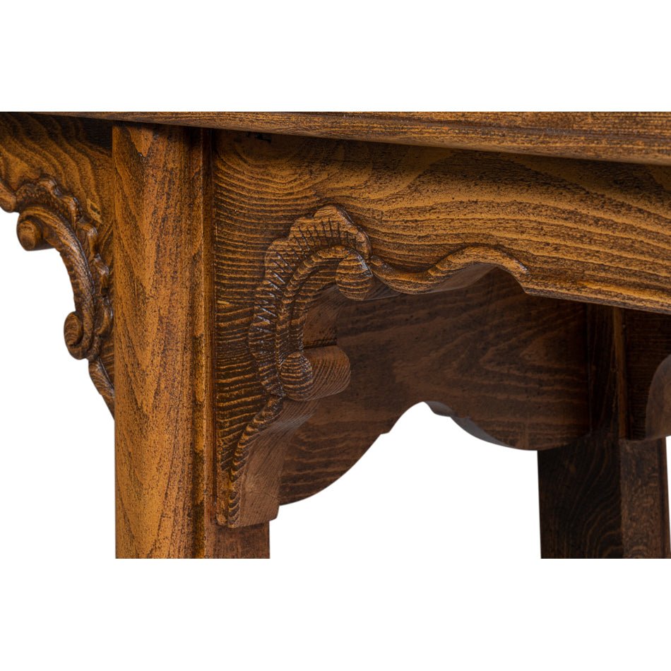 Detailed view of ornate carving under console table top.
