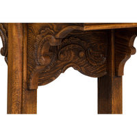 Close-up of intricate leg carving on console table.