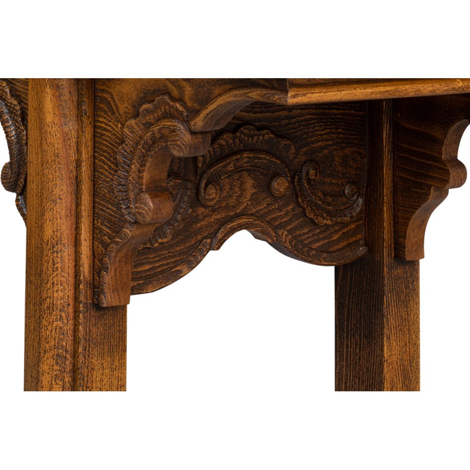 Close-up of intricate leg carving on console table.