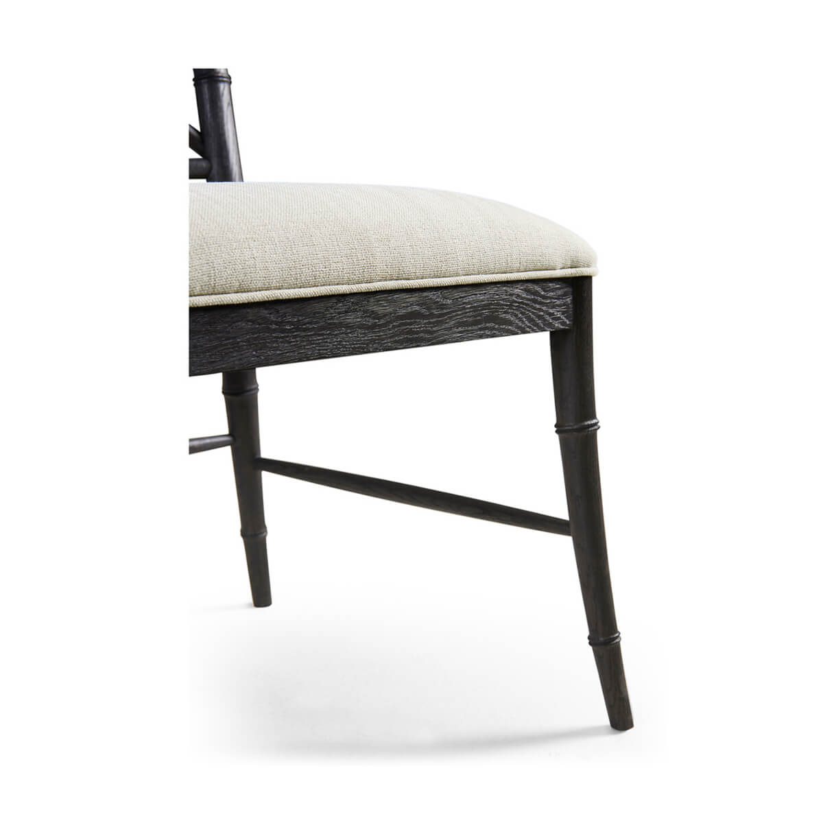 Close-up of chair seat and leg showing wood texture.