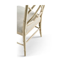 Close-up of chair's leg and seat upholstery detail.