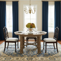 Dining room with Chippendale chairs around table.