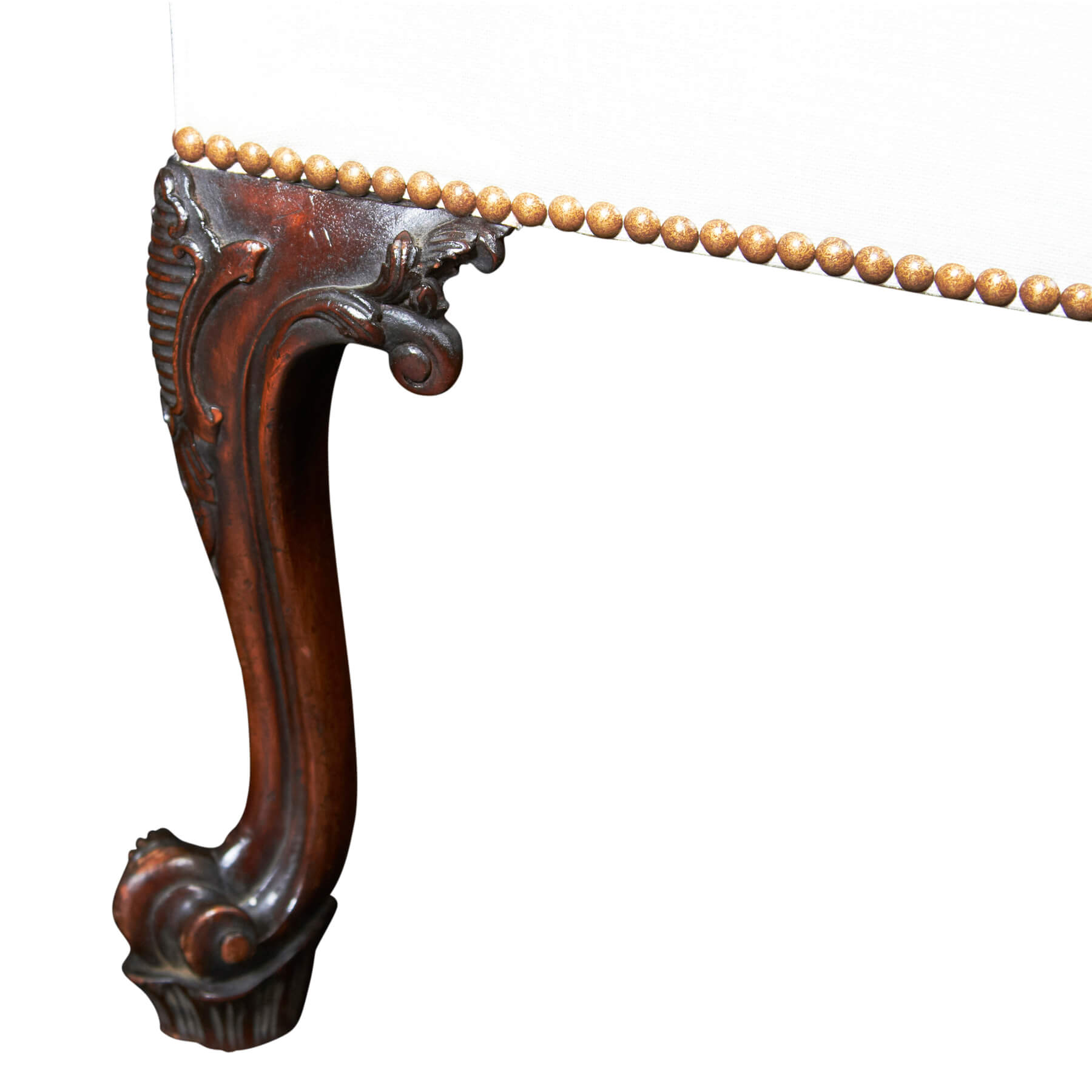 Close-up of ornate Chippendale Gainsborough chair leg carving.