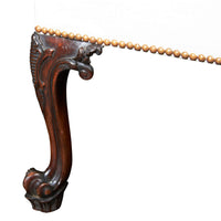 Close-up of ornate Chippendale Gainsborough chair leg carving.