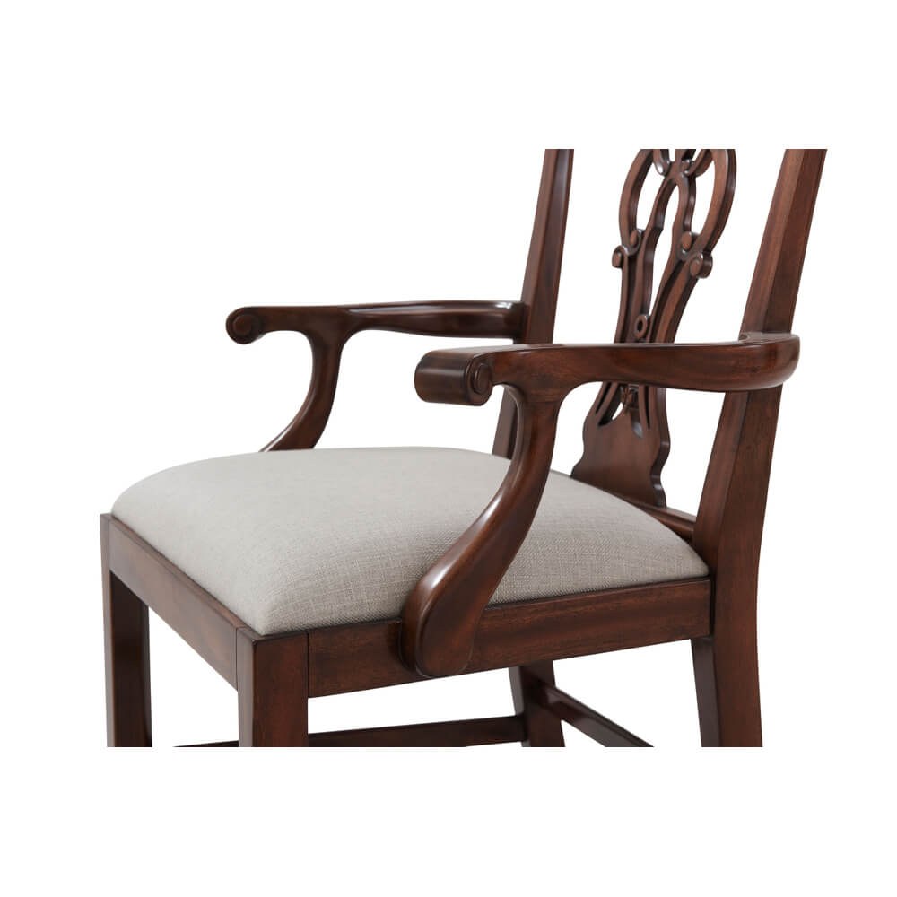 Armrest and seat detail on mahogany dining armchair.