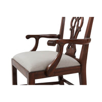 Armrest and seat detail on mahogany dining armchair.