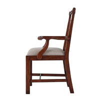 Side profile of mahogany dining armchair with armrests.