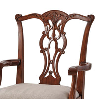 Close-up of backrest design on mahogany dining armchair.