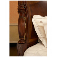 Side view of bedpost carving on mahogany bed.
