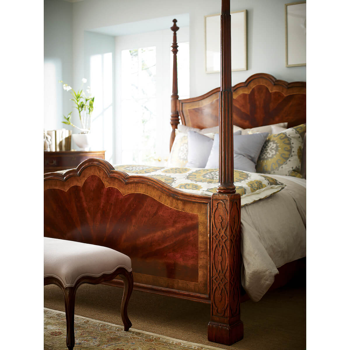 Mahogany four post bed with elegant bedding and decor.