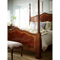 Mahogany four post bed with elegant bedding and decor.