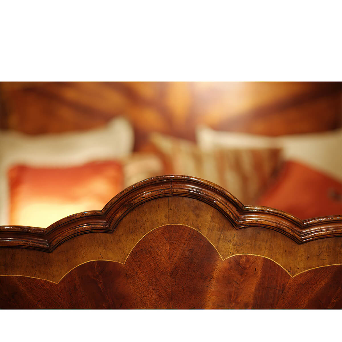 Elegant headboard design on mahogany four post bed.