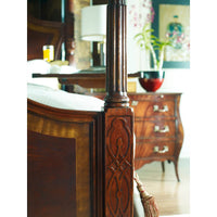 Carved post detail on mahogany four post bed.