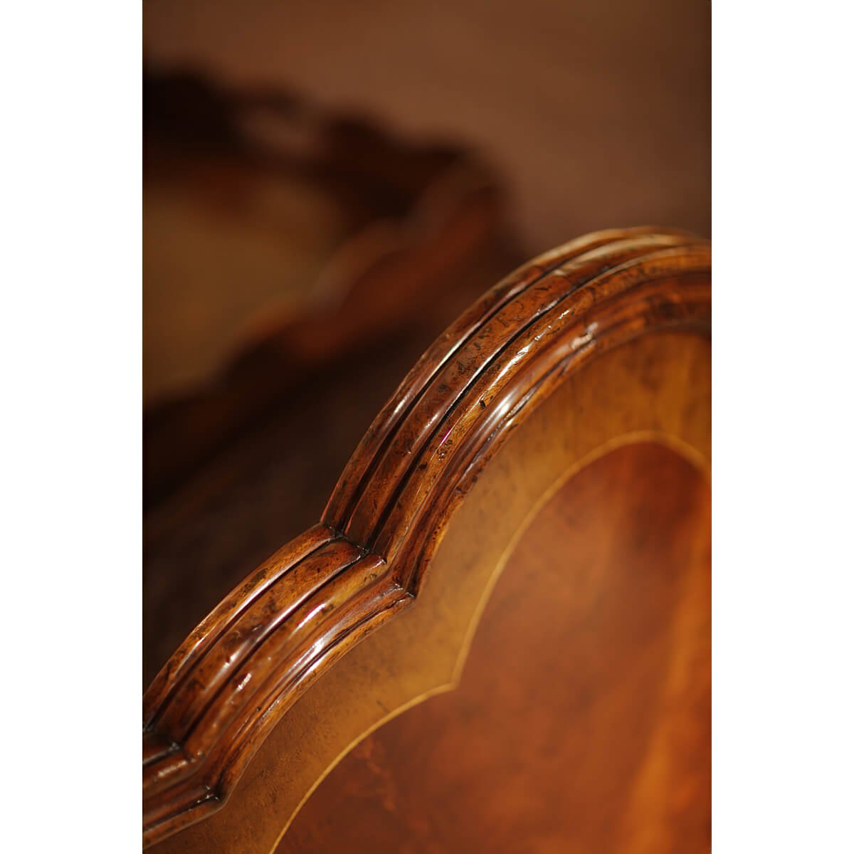 Close-up of carved edge on mahogany bed frame.